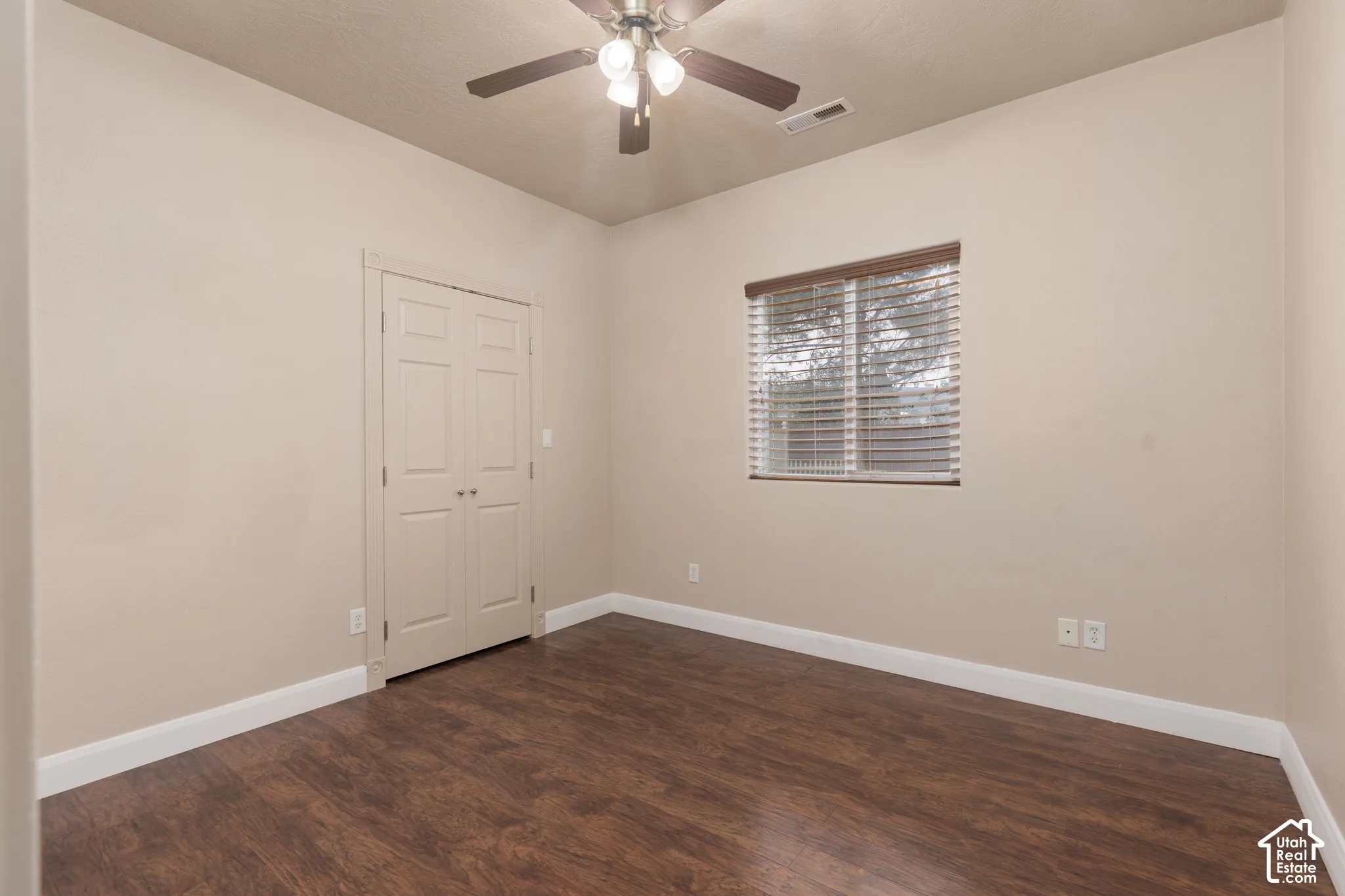Bedroom 4 featuring dark wood finished floors and ceiling fan