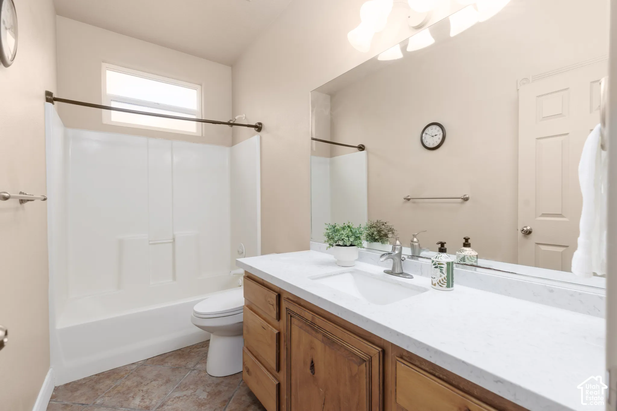 Bathroom with vanity,  shower combination, and light tile patterned floors