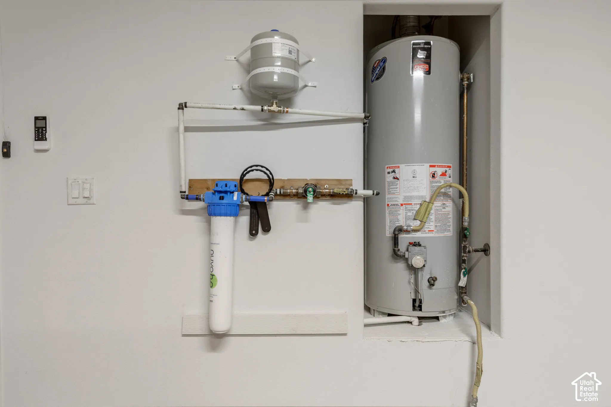 Utilities featuring water heater, water softener, split cell unit.