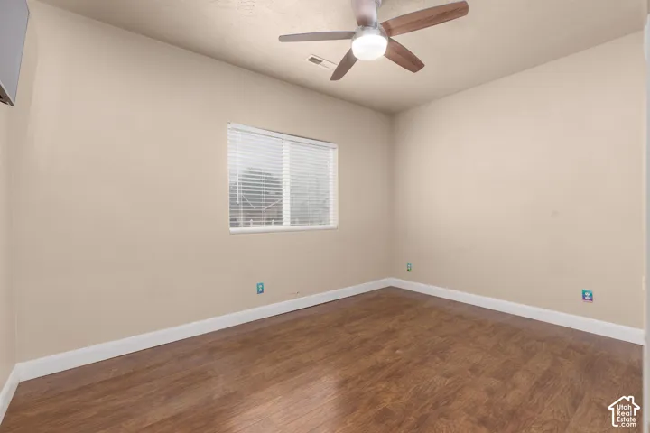 Bedroom 2 featuring dark wood-style floors and a ceiling fan
