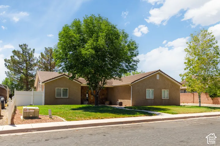 Spacious front yard with mature trees providing natural shade
