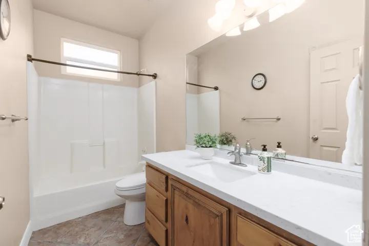 Bathroom with vanity,  shower combination, and light tile patterned floors