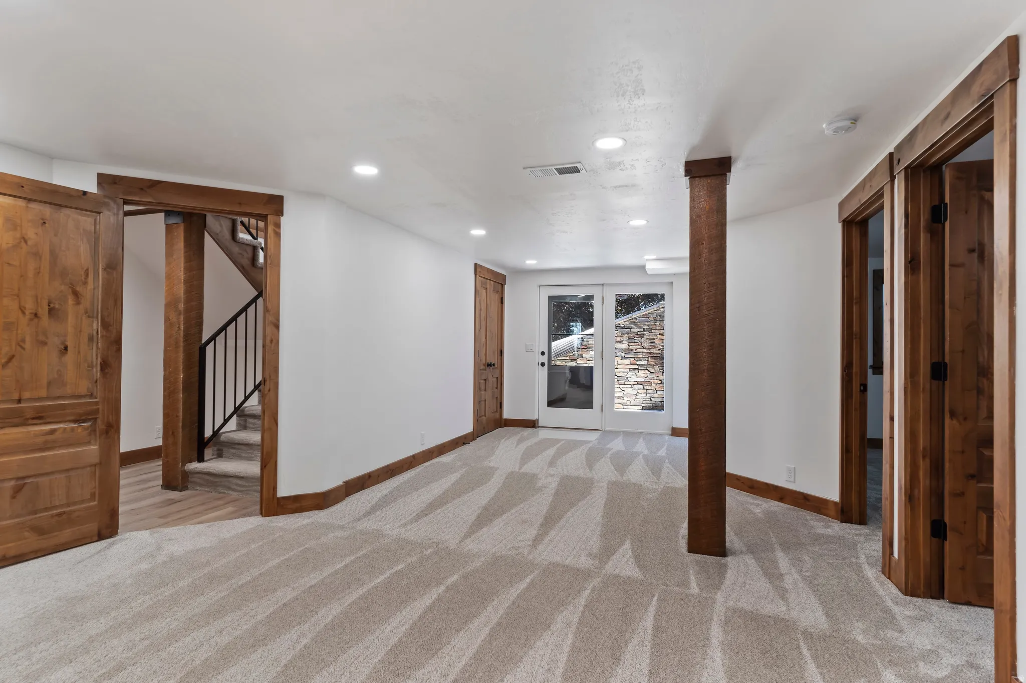 Unfurnished living room featuring light carpet and recessed lighting
