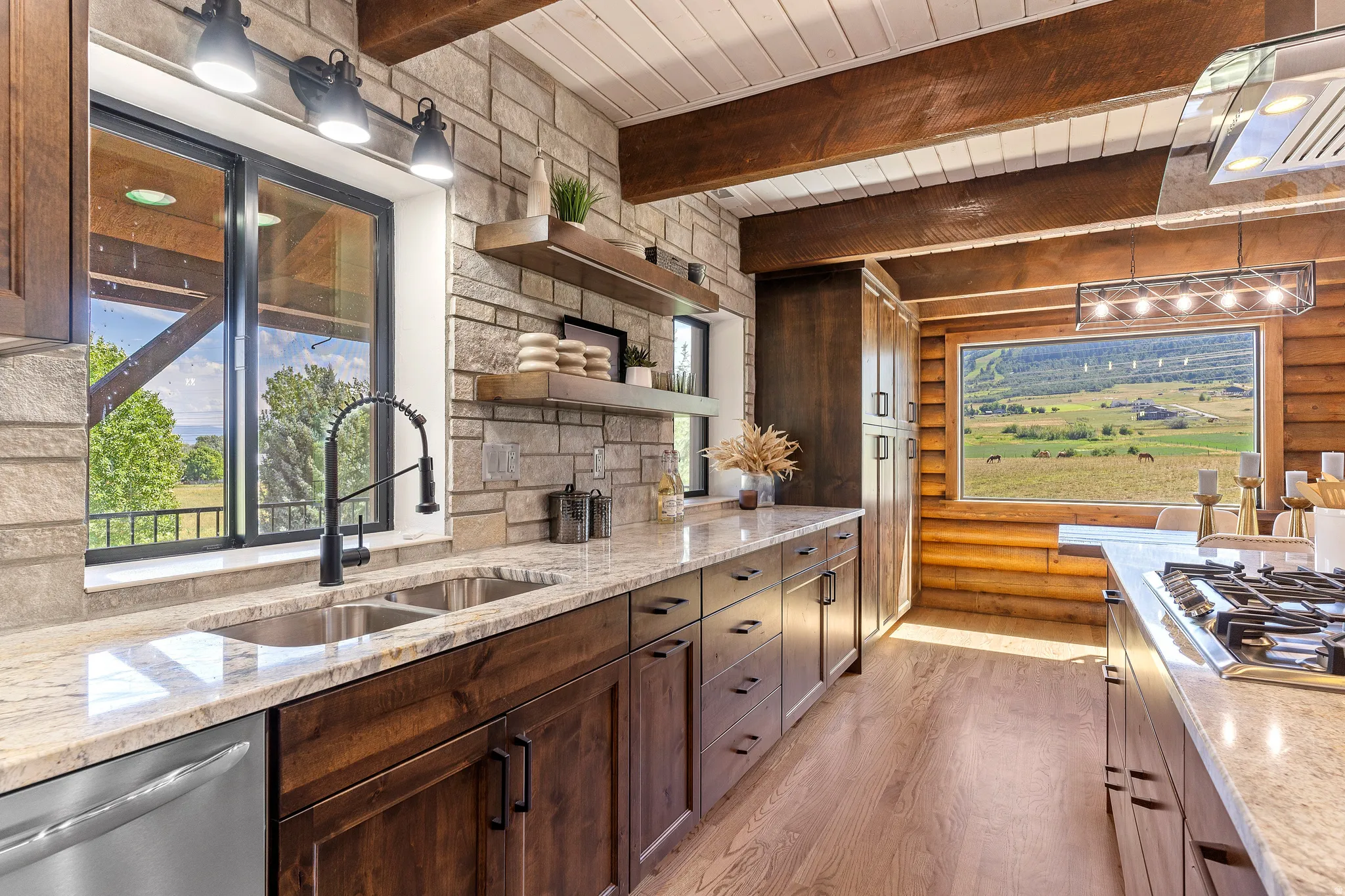 Kitchen with open shelves, light stone countertops, stainless steel appliances, light wood-type flooring, and rustic walls