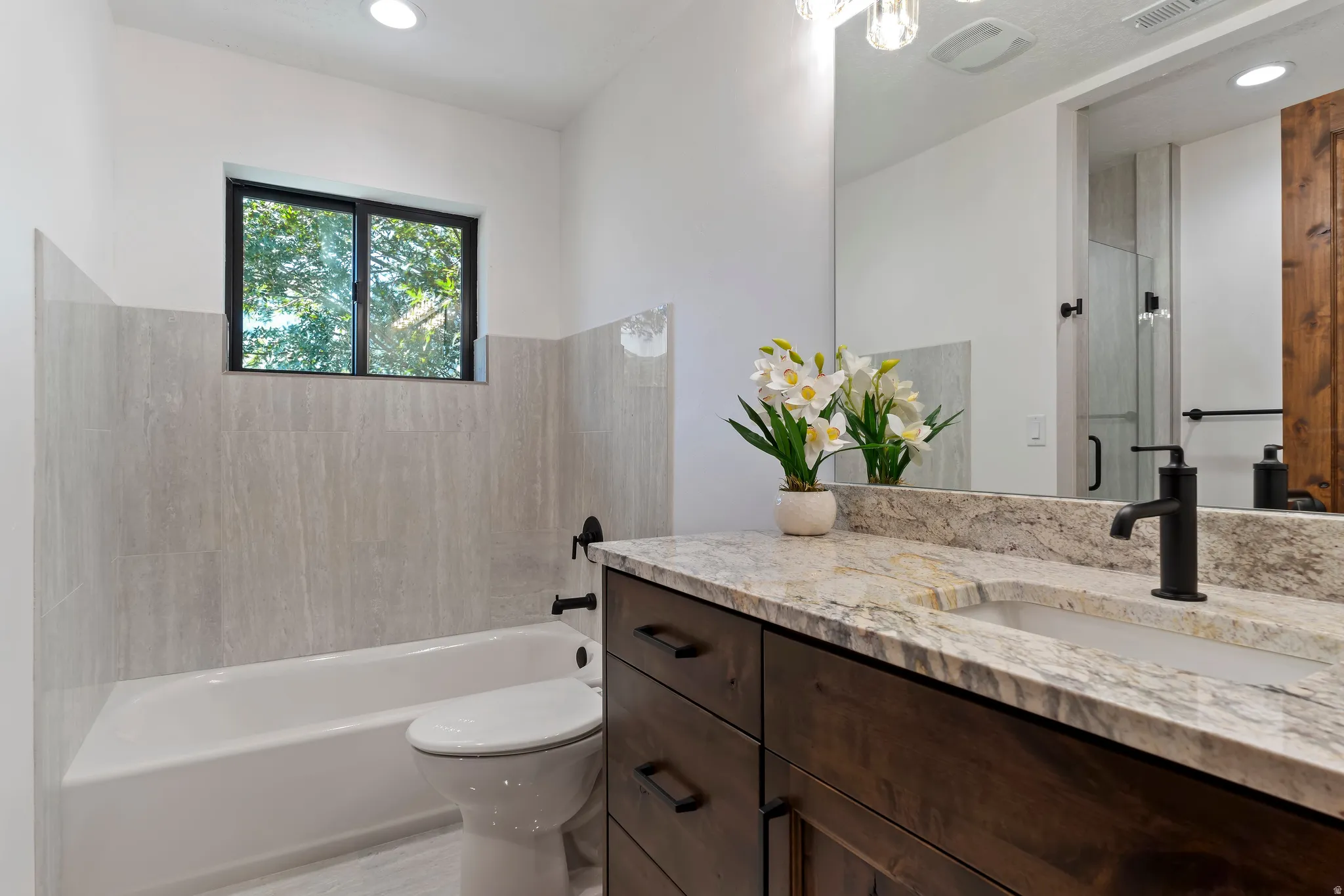Bathroom with vanity, enclosed tub / shower combo, and recessed lighting