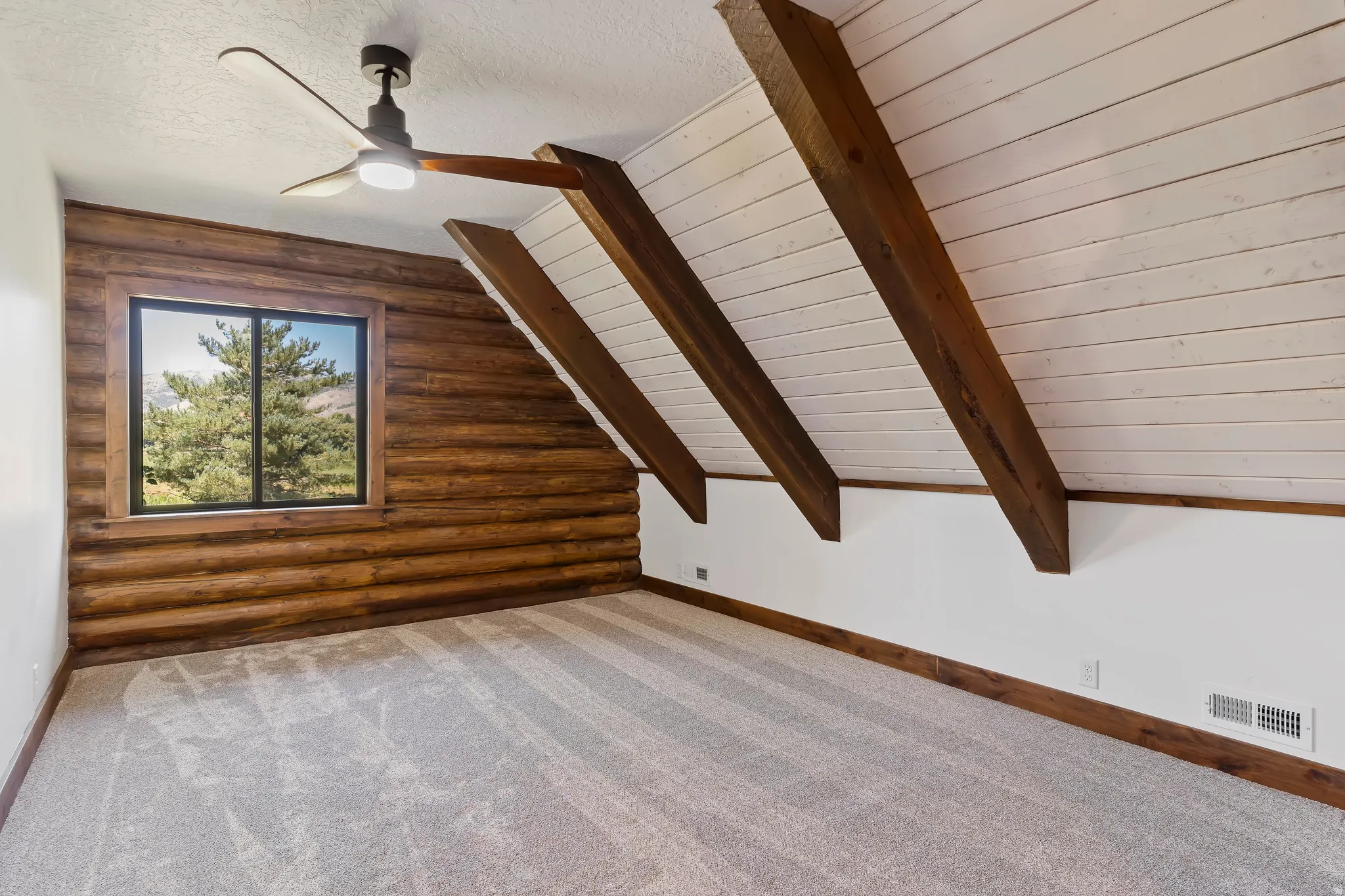 Bonus room featuring log walls, carpet, vaulted ceiling with beams, a ceiling fan, and wood ceiling