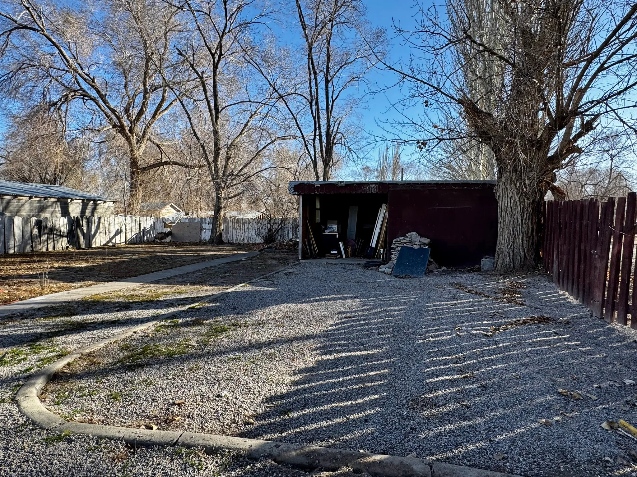 Fenced backyard with an outdoor structure
