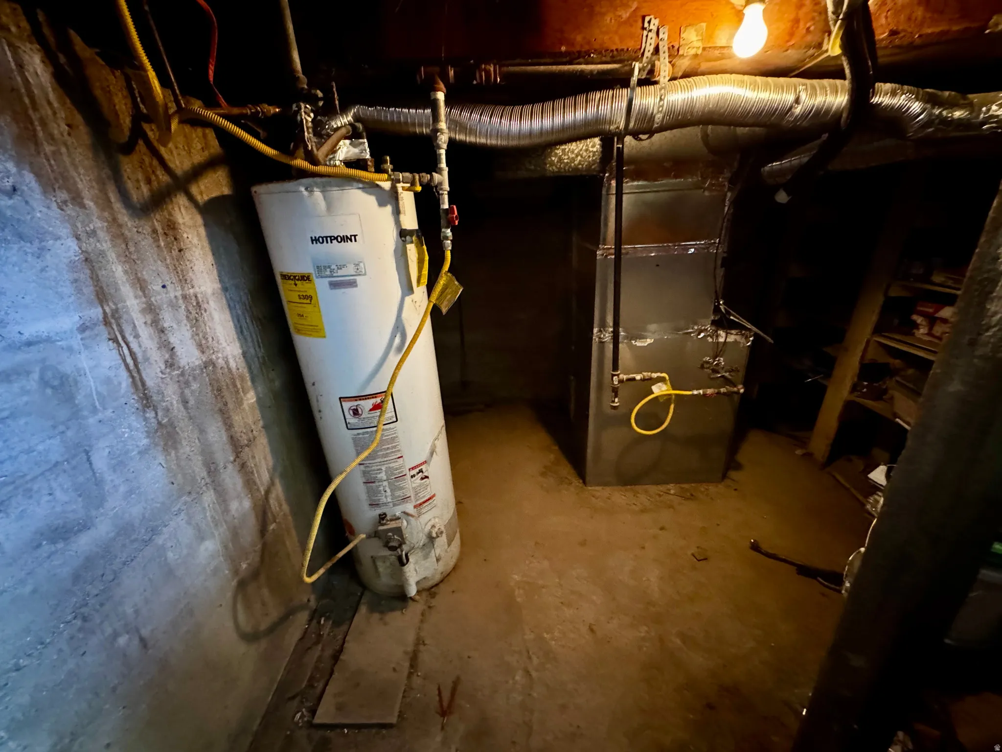 Utility room with water heater and heating unit