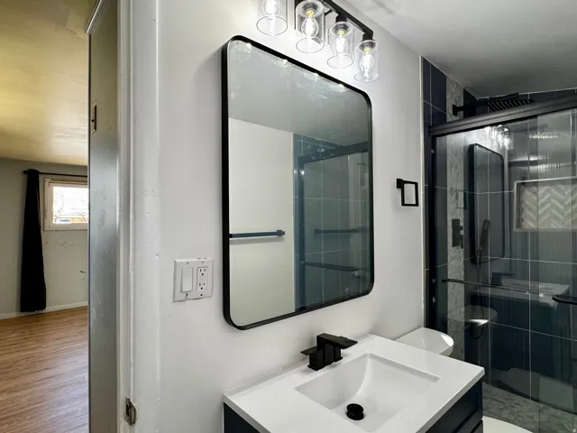 Bathroom featuring vanity and a shower stall