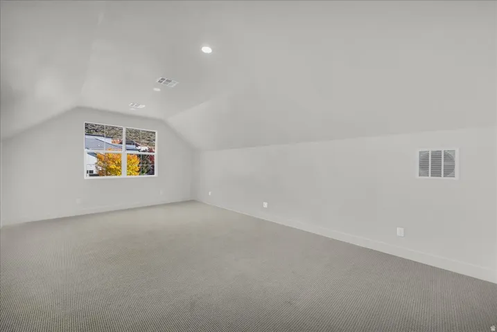 Additional living space with carpet floors and recessed lighting