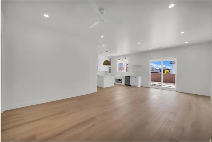 Unfurnished living room with ceiling fan, light wood finished floors, and recessed lighting