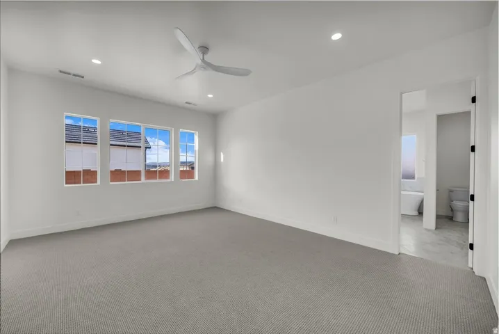 Empty room with ceiling fan, carpet floors, and recessed lighting