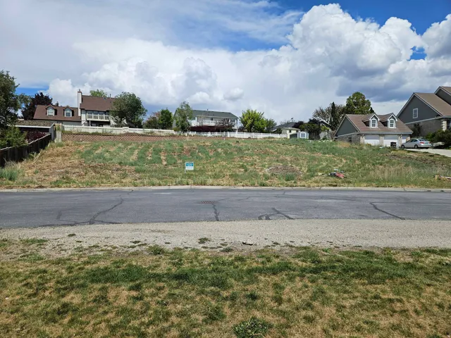 Elevated building lot featuring a sloped terrain and partial retaining wall