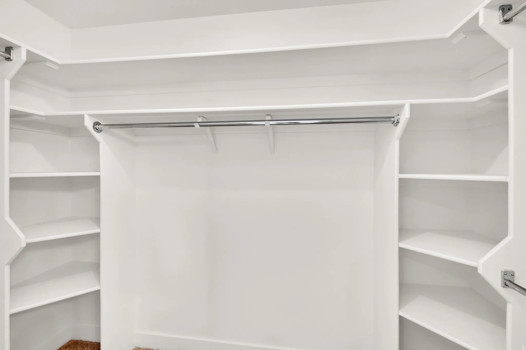View of primary walk in closet