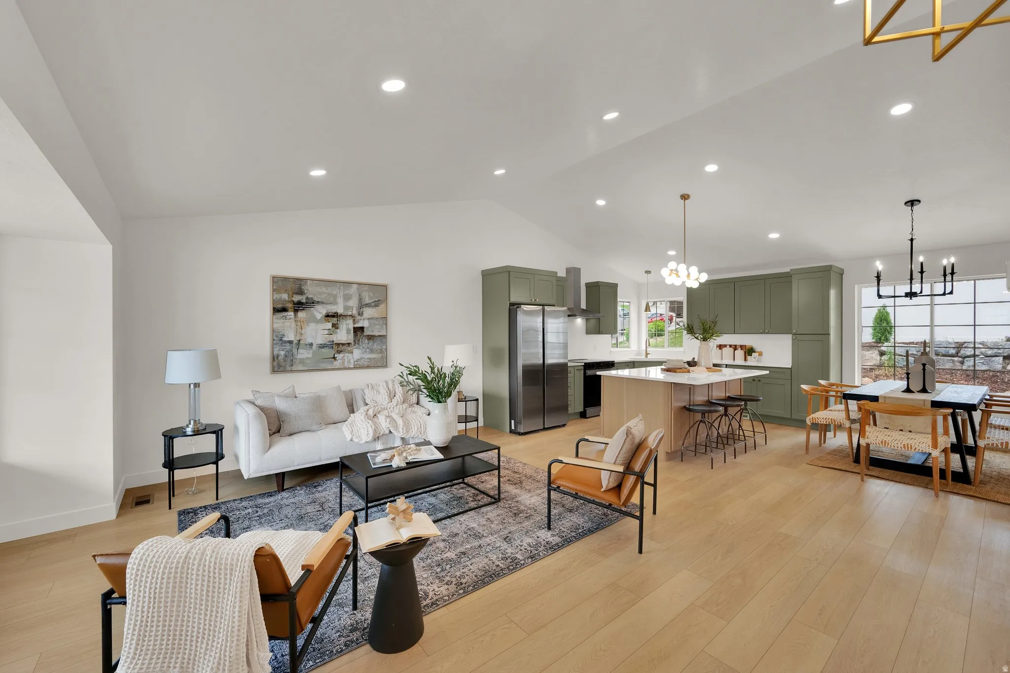 Living room with light wood-style floors and hanging lights