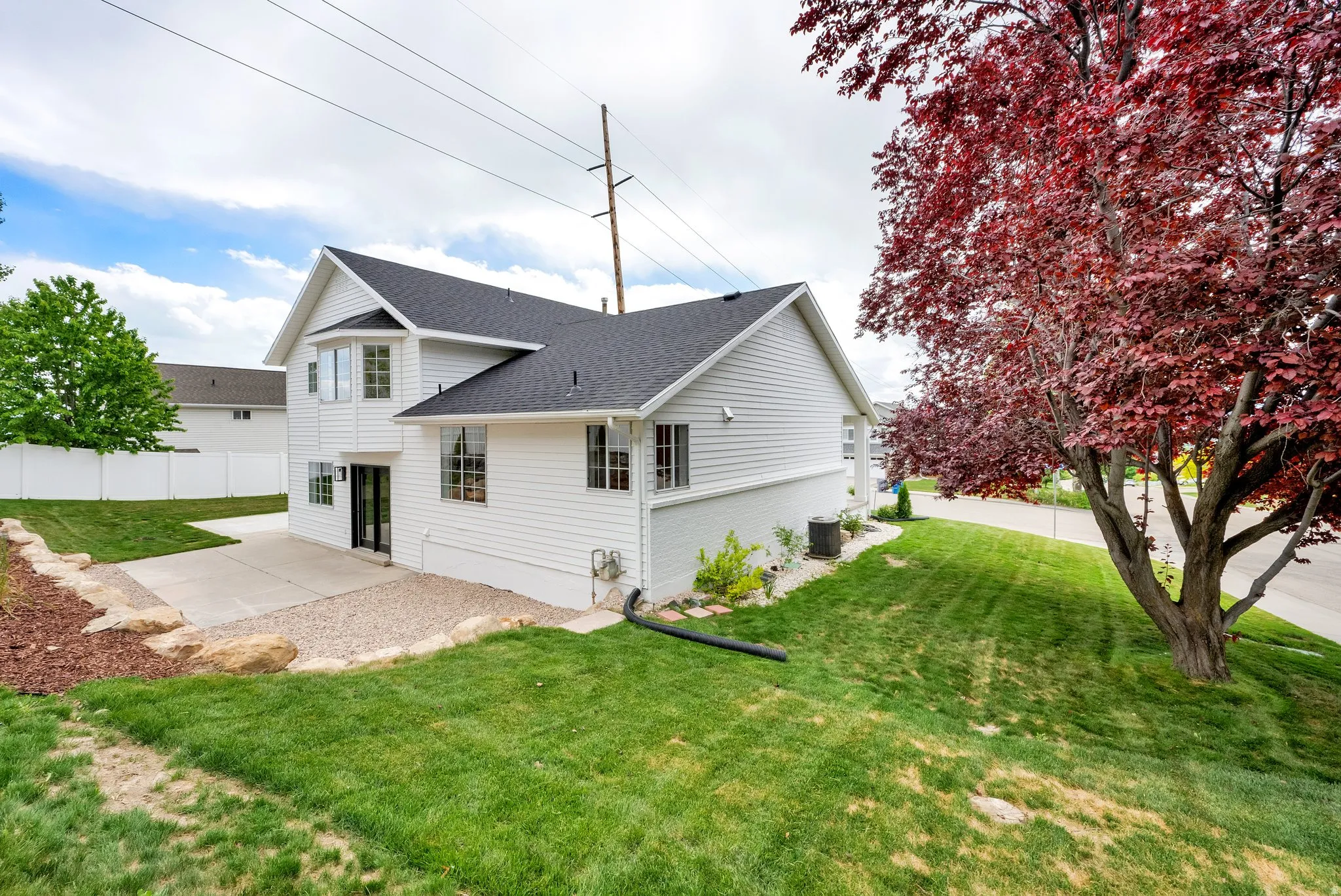 Rear view of property with roof with shingles and a patio