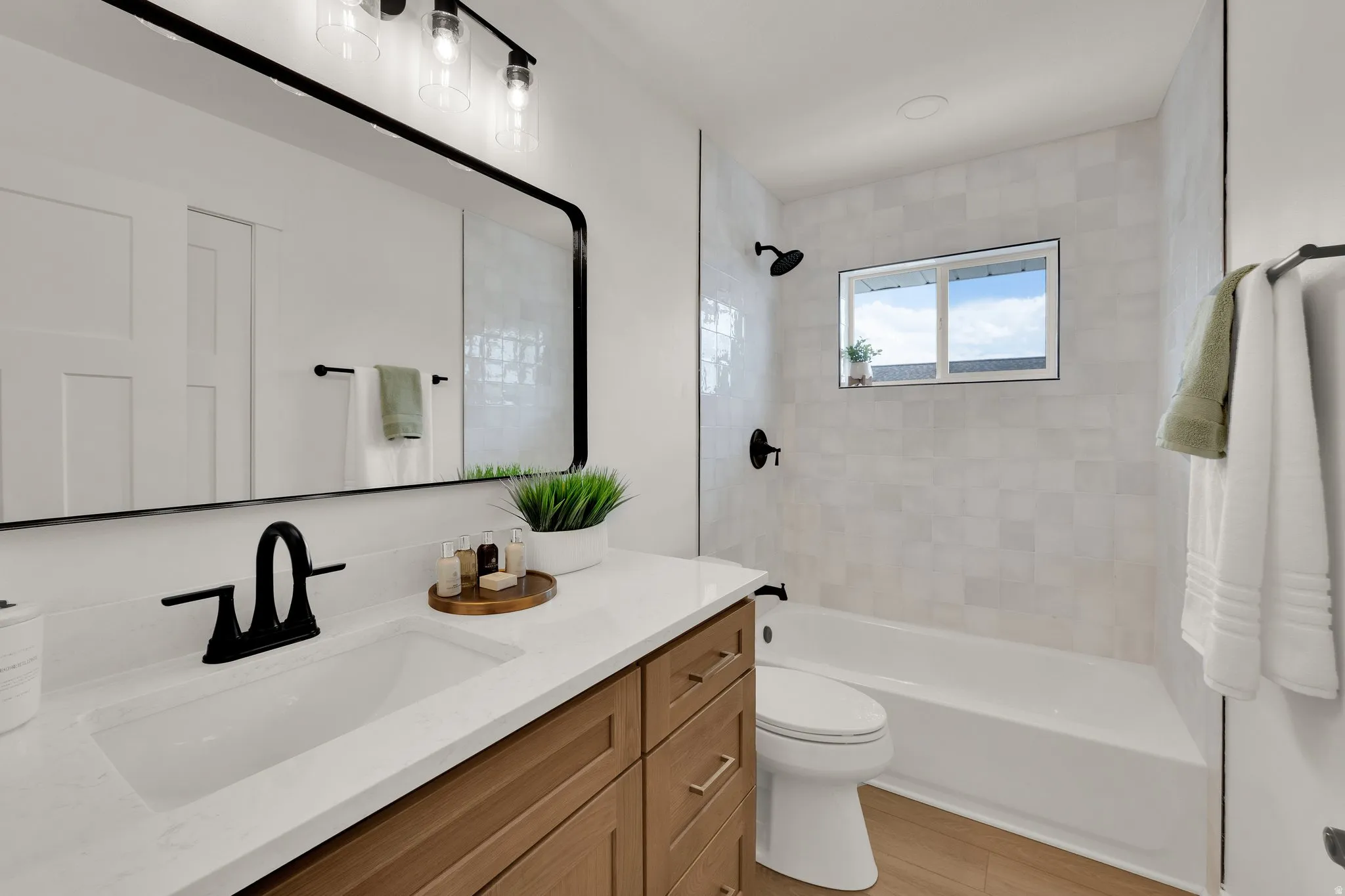 Upstairs 2nd Bathroom featuring vanity and tub / shower combination