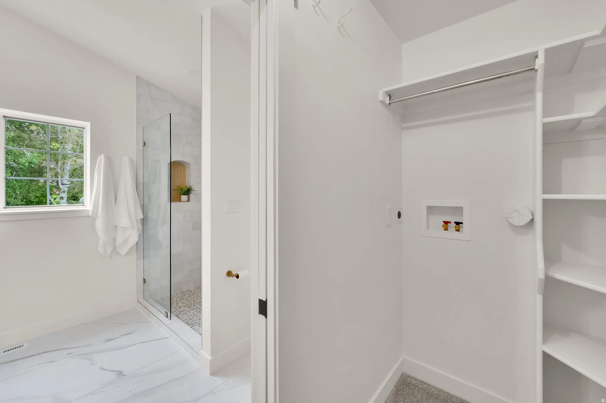 Primary Closet Laundry area with hookup for a washing machine and light marble finish flooring