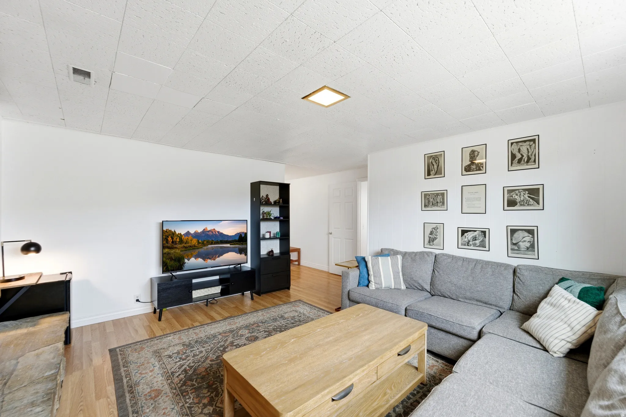 Living area featuring light wood-style flooring and baseboards