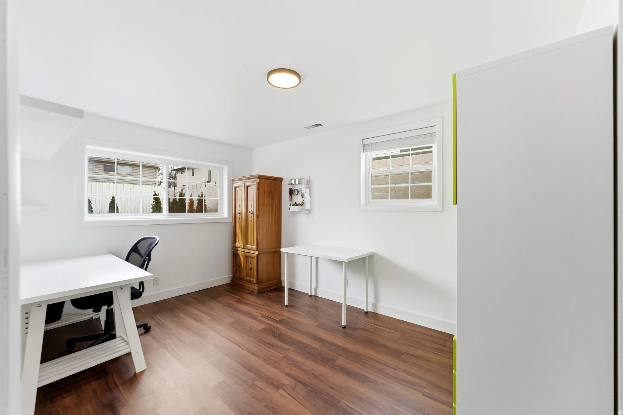Home office featuring baseboards and dark wood-style flooring