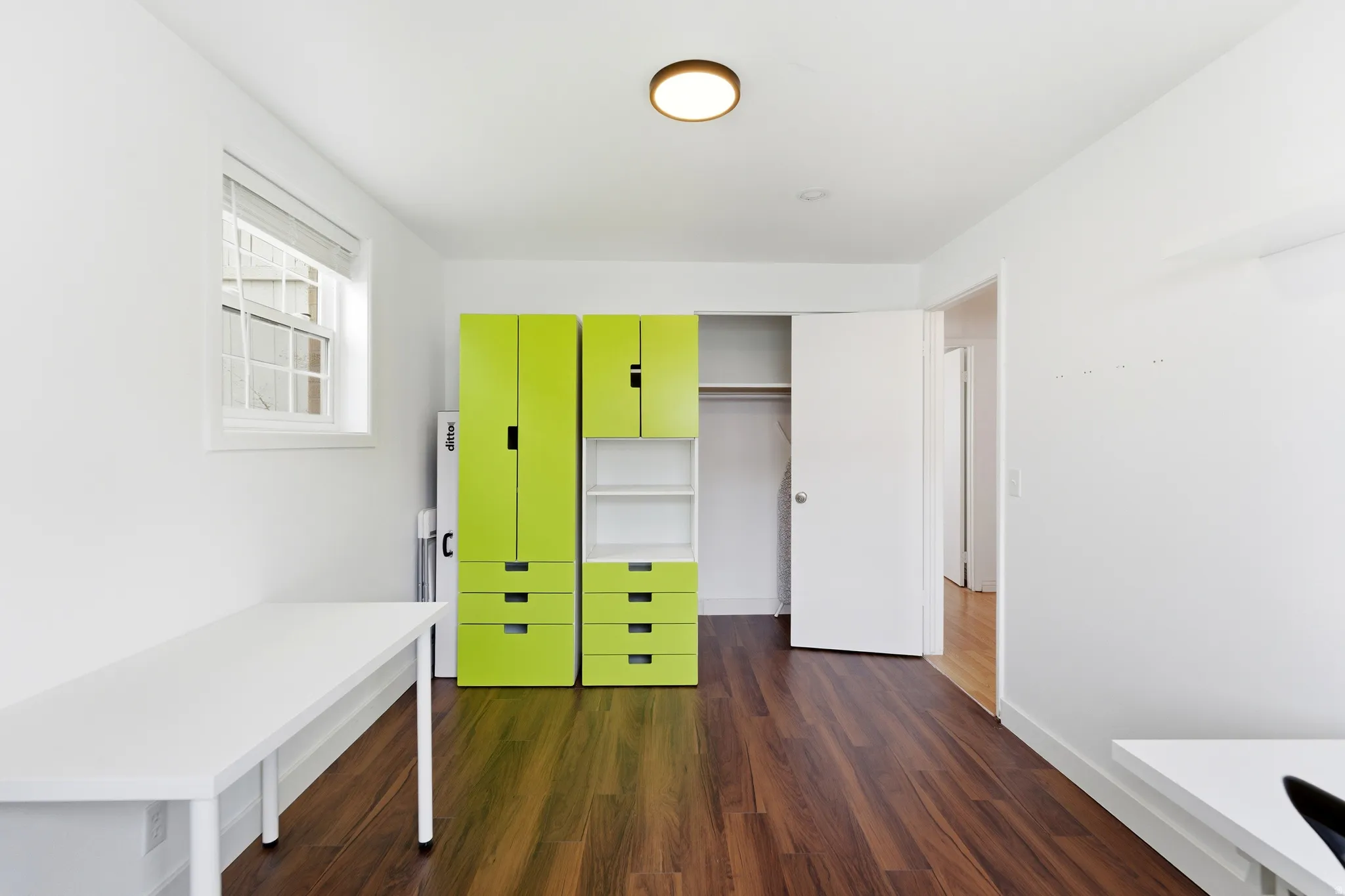 Unfurnished bedroom featuring dark wood-style flooring and a closet