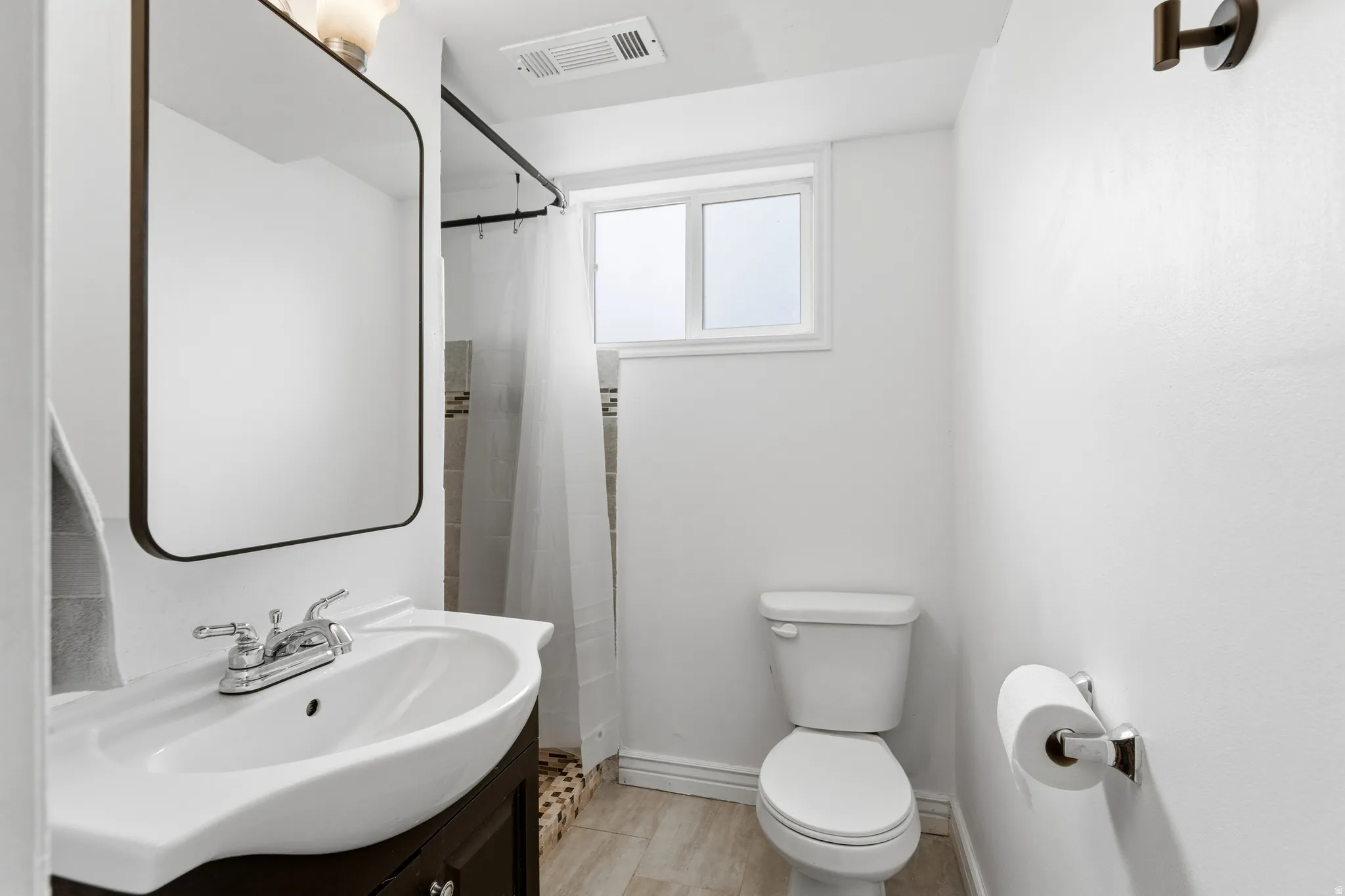 Full bath featuring vanity and a shower with curtain