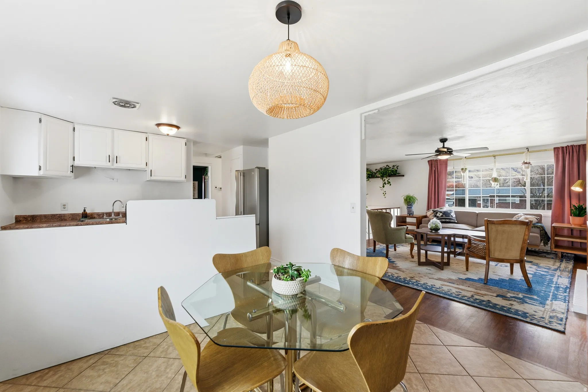 Dining space with a ceiling fan and light tile patterned flooring