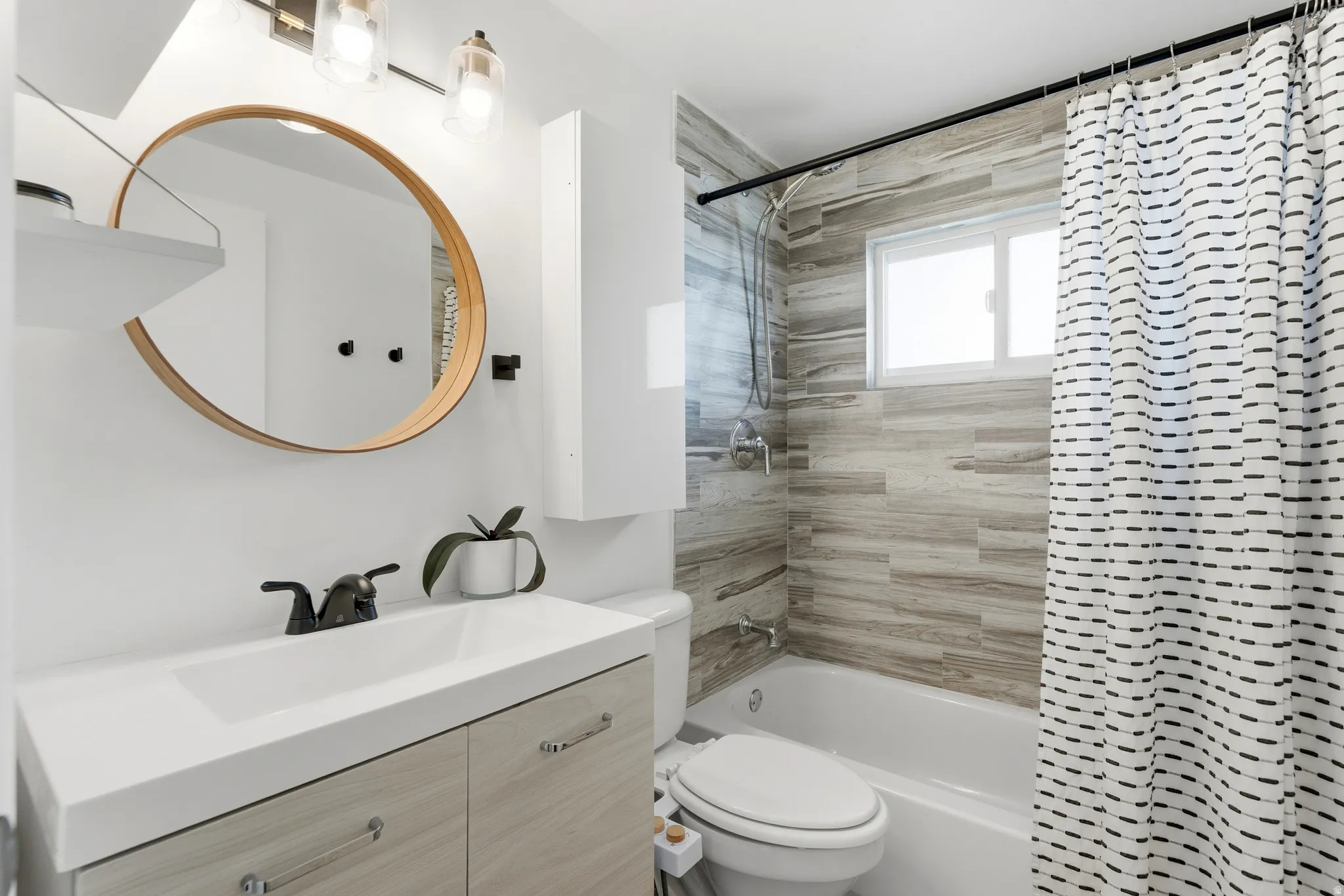 Bathroom featuring shower / bath combo with shower curtain and vanity