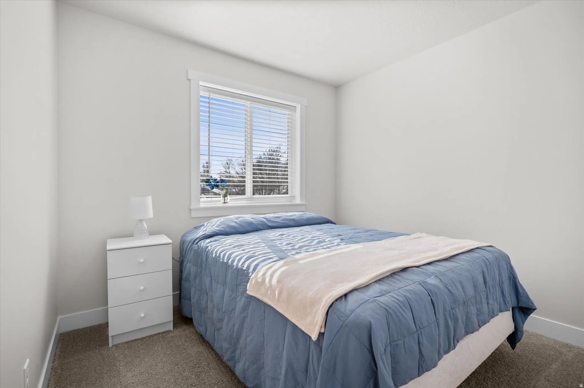 Carpeted bedroom with baseboards