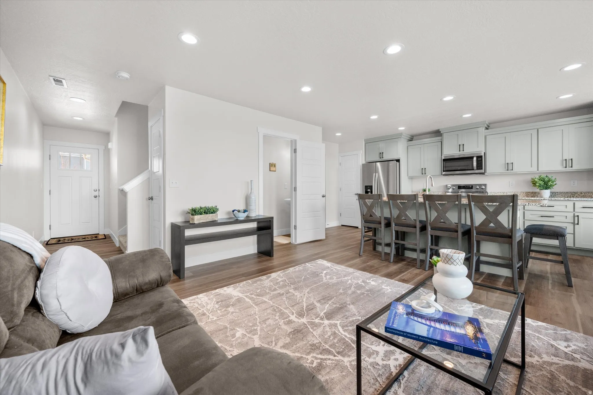Living area featuring dark wood-style floors and recessed lighting