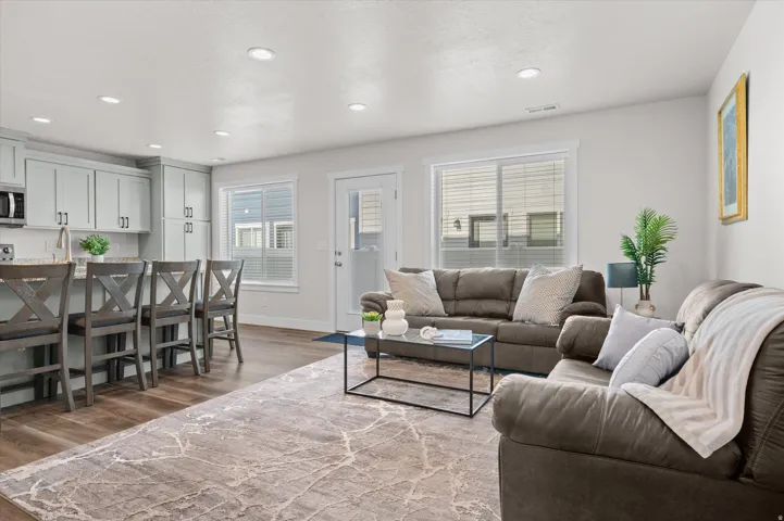 Living room with dark wood-style flooring and recessed lighting