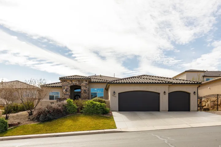 Mediterranean / spanish-style house with a garage, stucco siding, concrete driveway, and a tiled roof