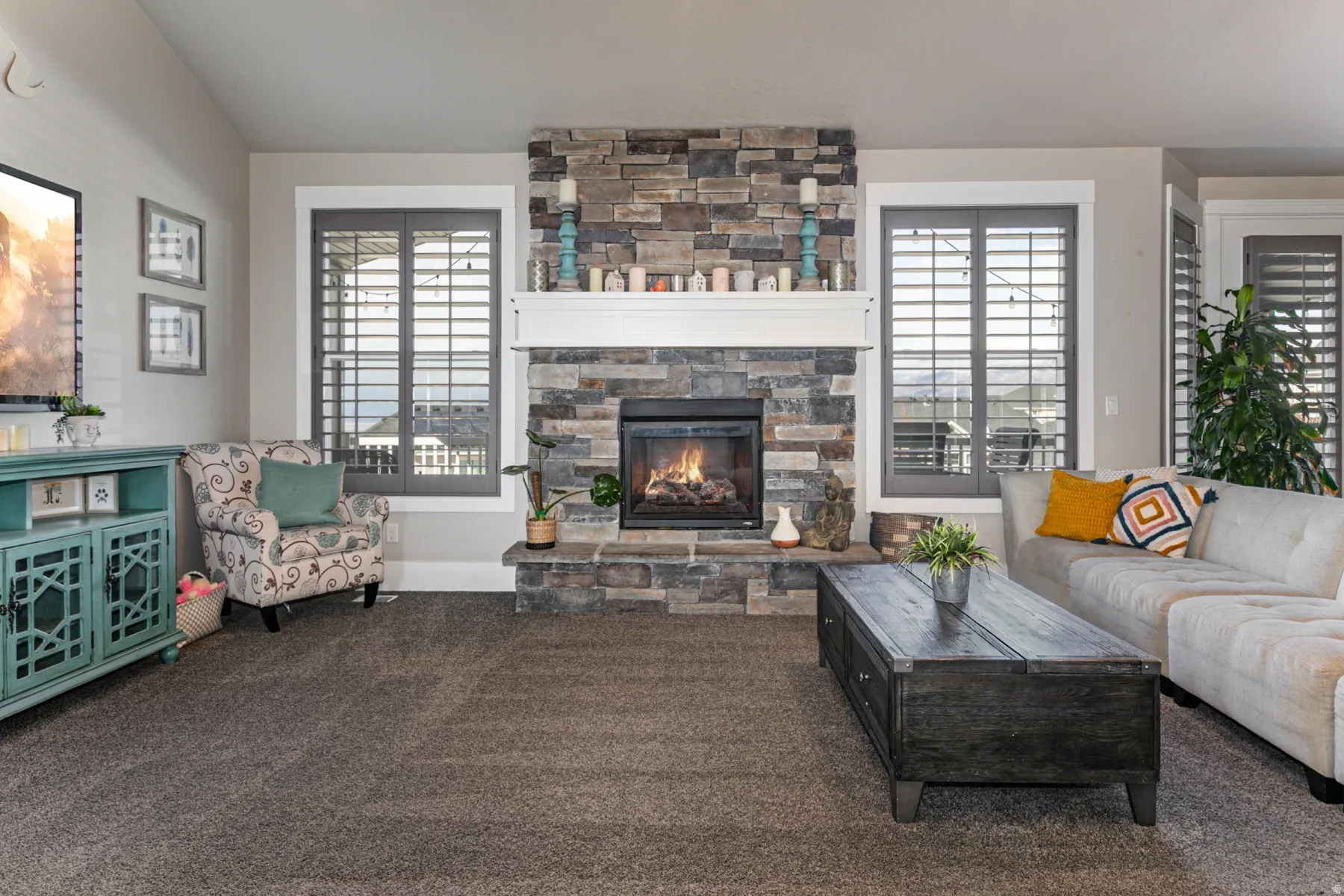 Living room featuring carpet, a fireplace, and plenty of natural light