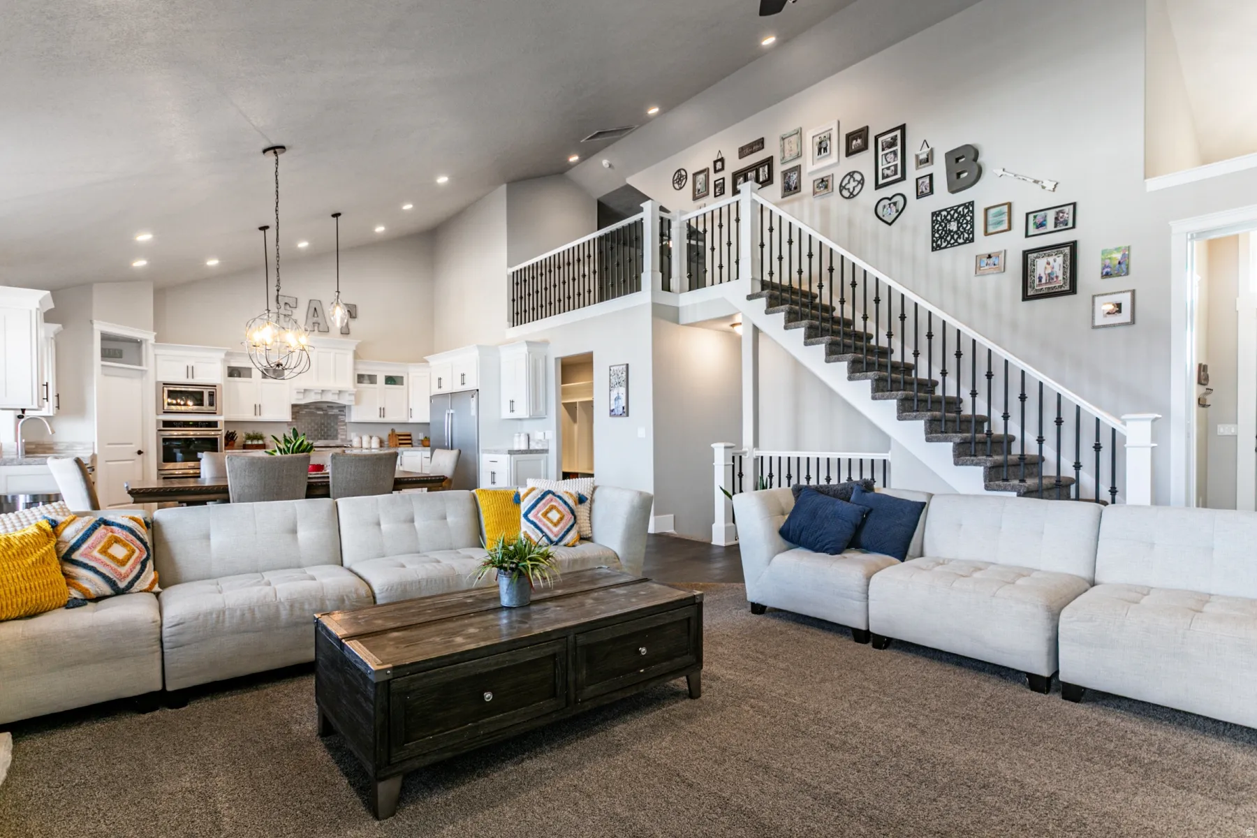 Living area featuring suspended lighting and lofted ceiling