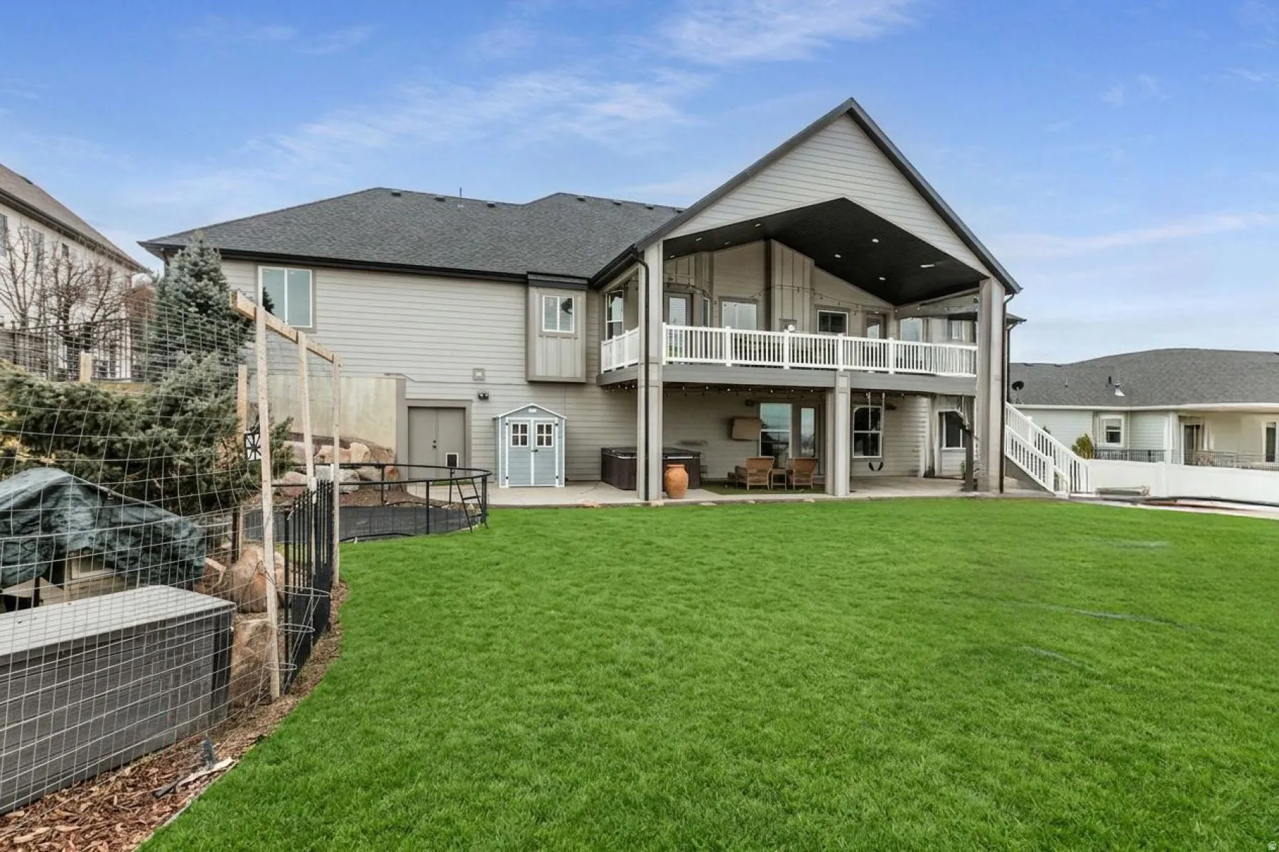 Rear view of house featuring a patio area, a fenced backyard, and roof with shingles