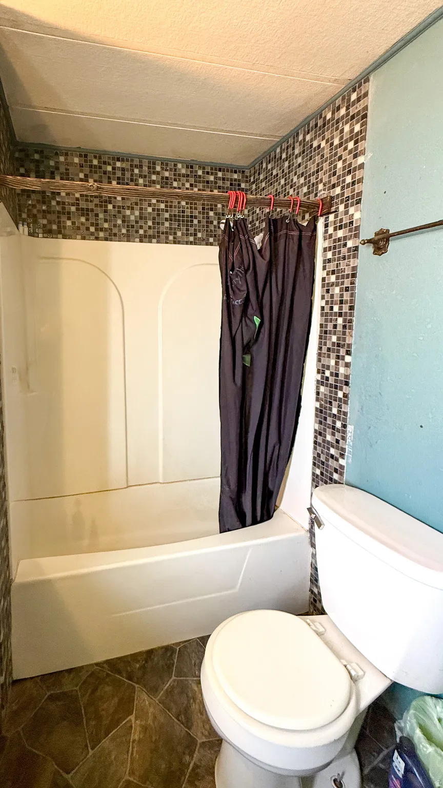 Full bathroom featuring shower / bath combo and toilet