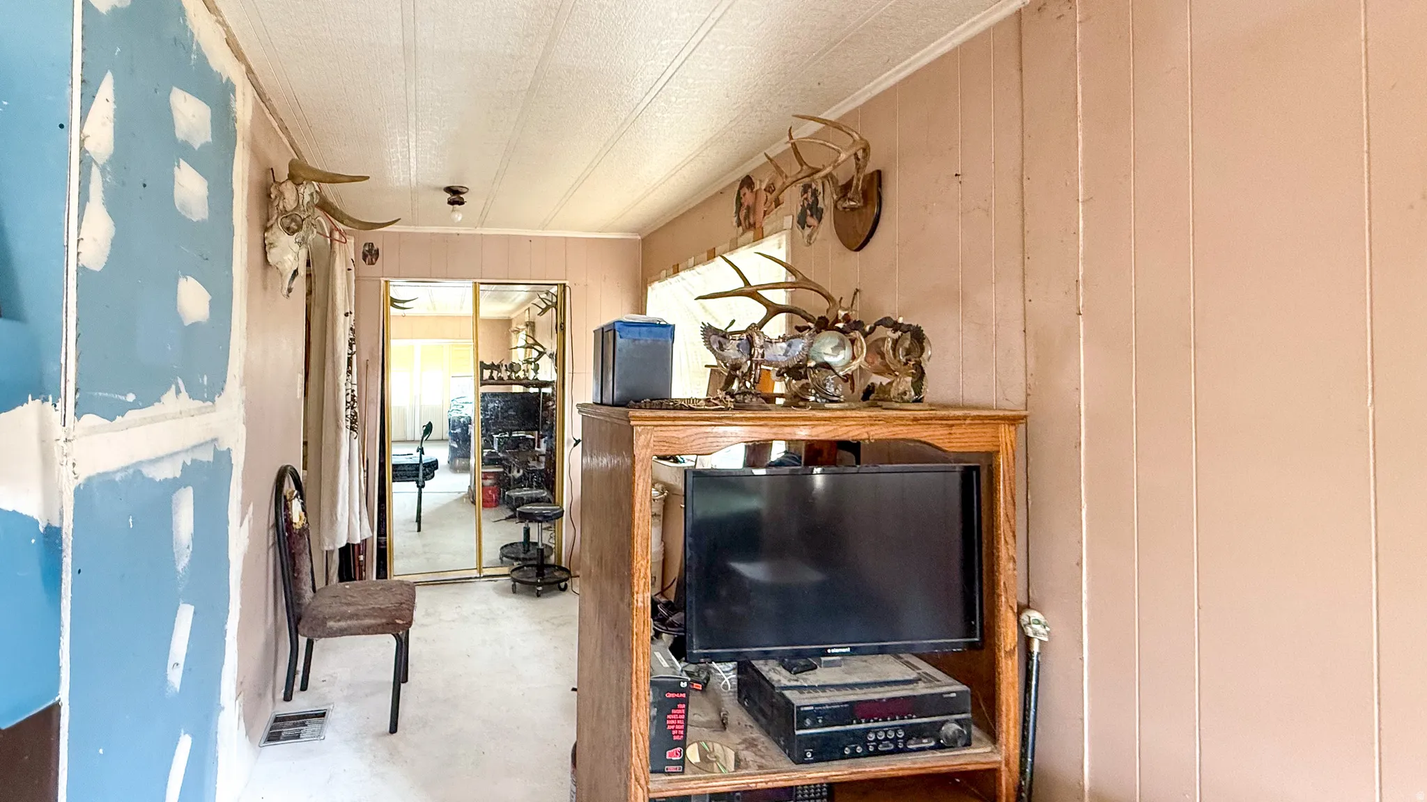 Interior space with wooden walls and concrete floors