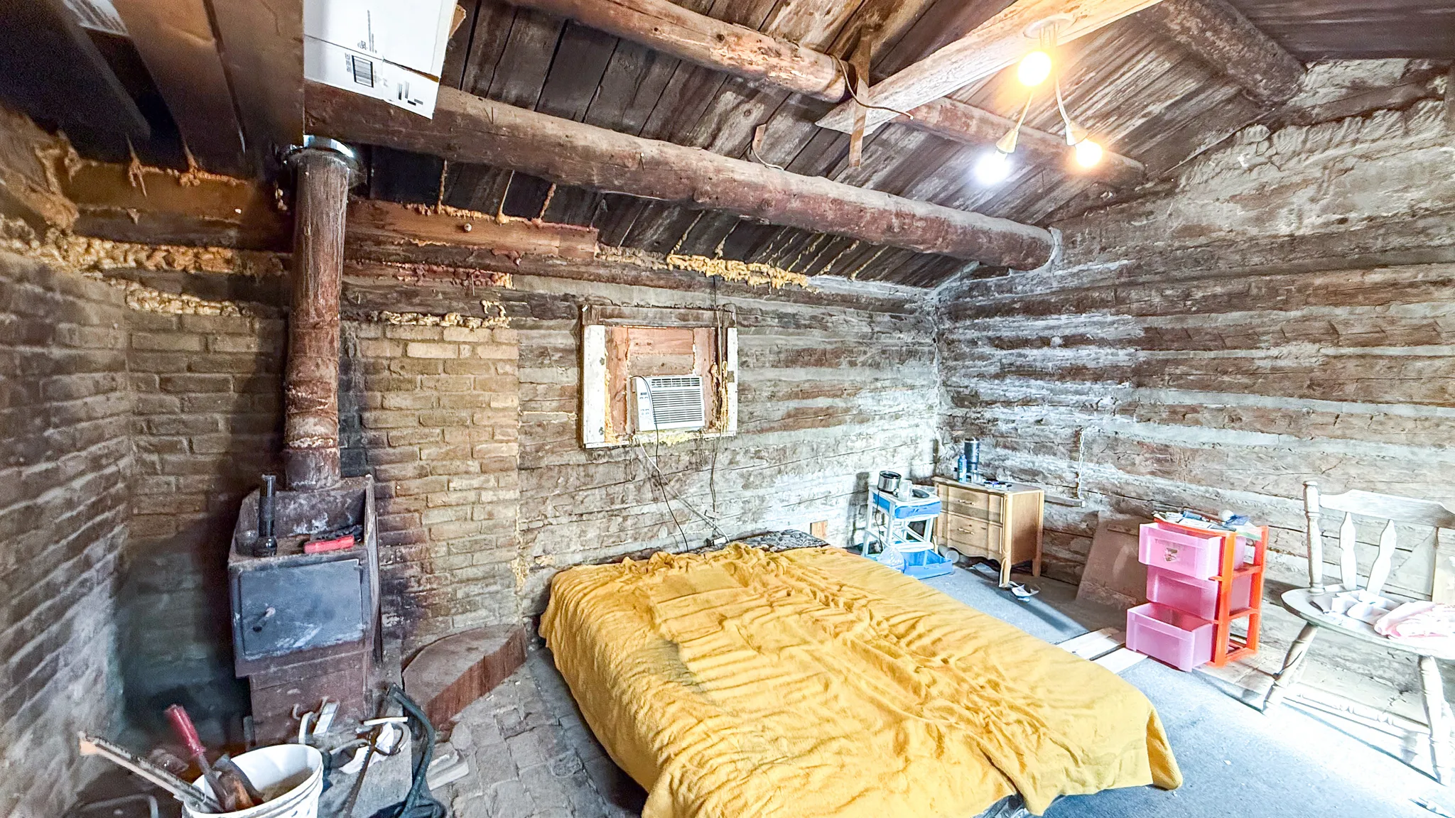 Cabin interior featuring a wood stove and lofted ceiling