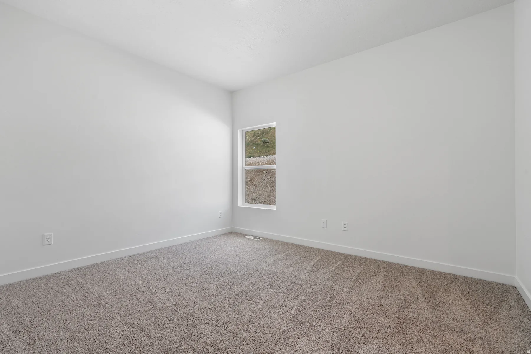 Unfurnished room with carpet flooring and baseboards