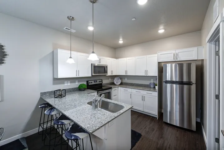 Kitchen featuring stainless steel appliances and granite countertops Example
