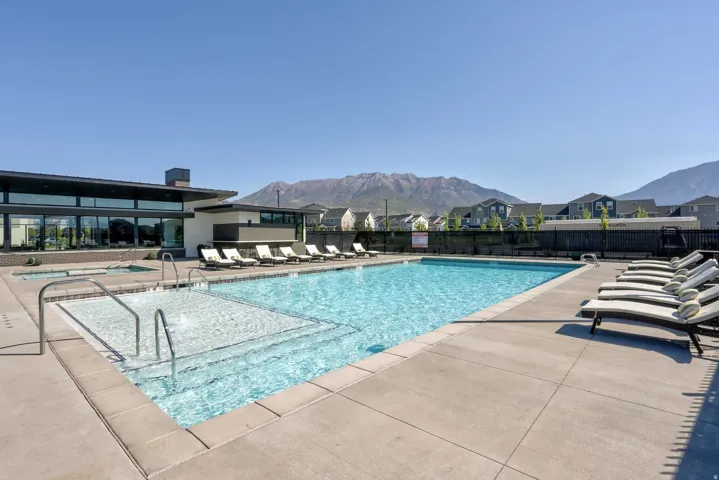 Community pool featuring a patio area, a mountain view, and a residential view