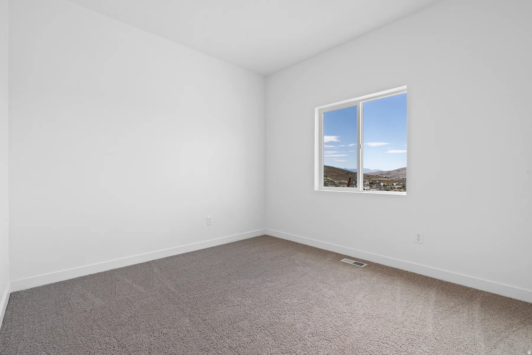 Unfurnished room featuring dark colored carpet and baseboards