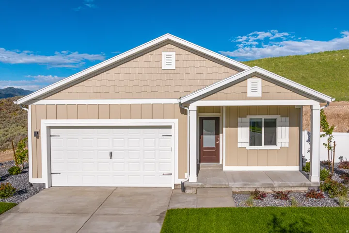 View of front of home with covered porch, an attached garage, concrete driveway, and board and batten siding
