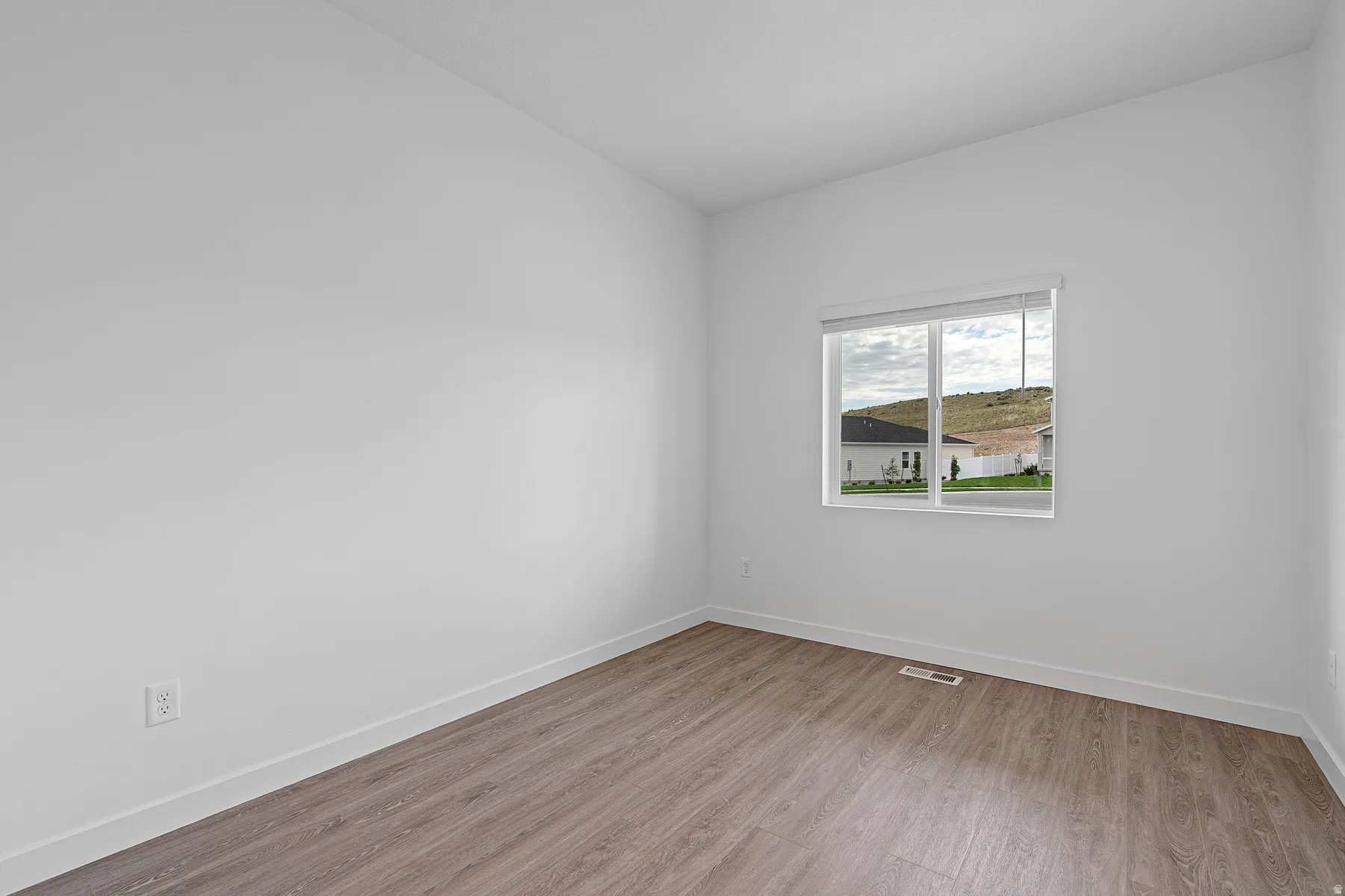 Unfurnished room featuring light wood-style flooring and baseboards