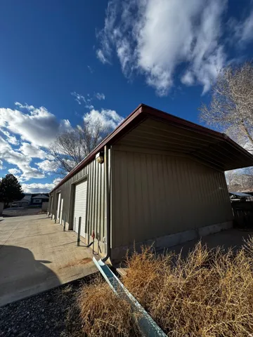 View of property exterior featuring an outbuilding
