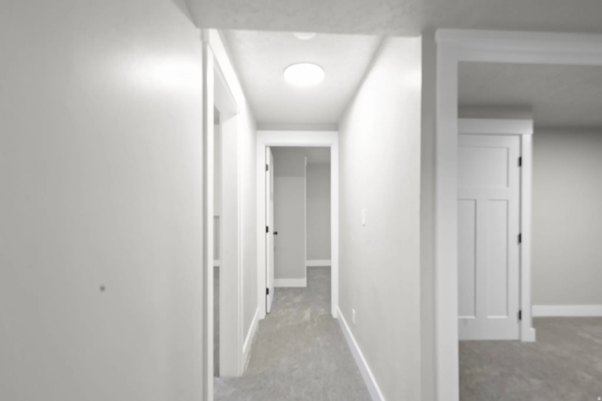 Hall featuring light carpet