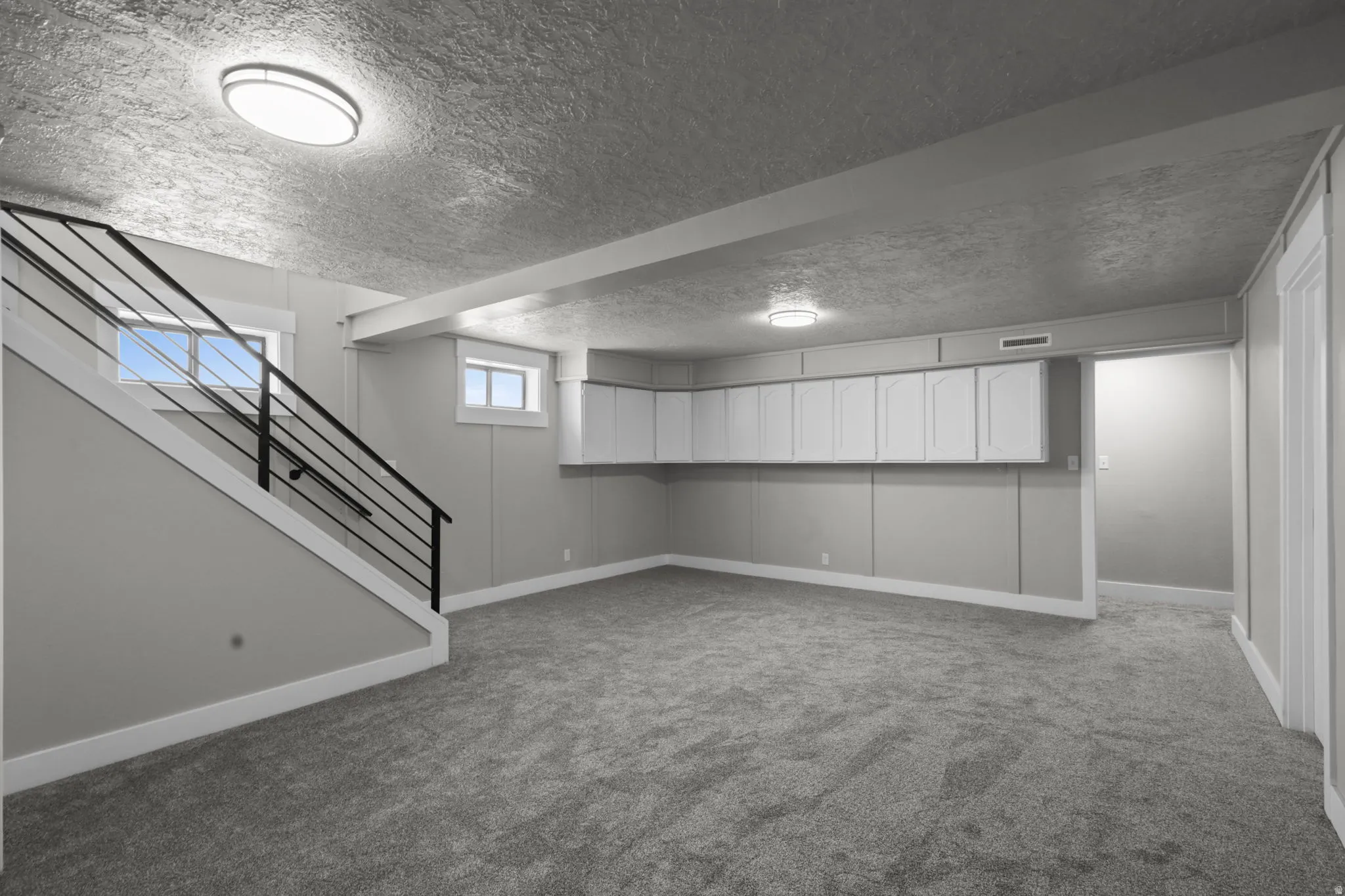 Basement featuring carpet and a textured ceiling