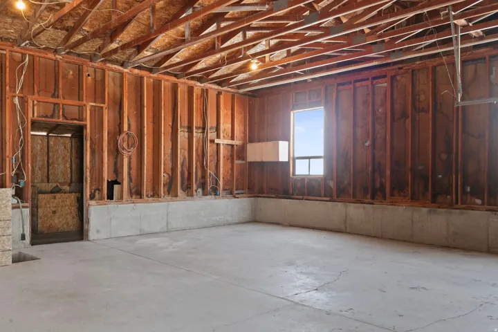 Misc room featuring concrete flooring and a garage