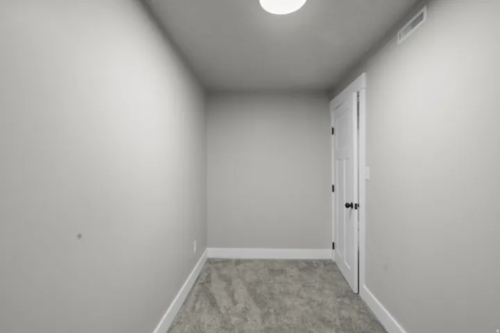 Hall with light carpet and baseboards