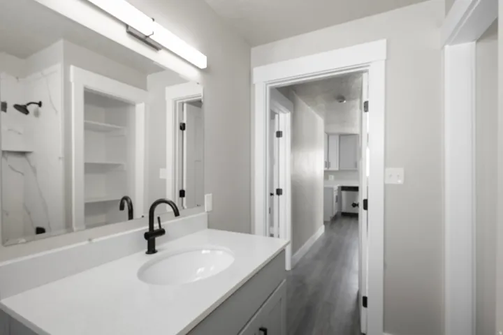 Bathroom with vanity and dark wood-style floors